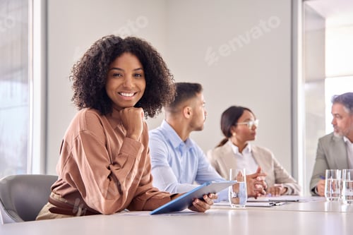 Preview: Portrait of happy young African American business woman at office meeting.