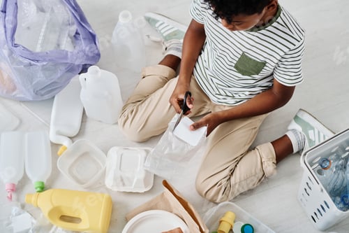 Preview: Boy separating rubbish in different containers