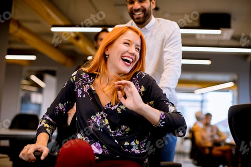 Preview: Young cheerful business people in smart casual wear having fun