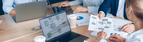 Preview: Focused business people are using gadgets and talking during the conference in office