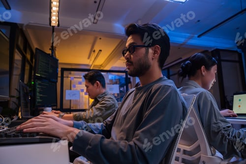 Preview: Young Asian business team working late at night in office meeting and coding presentation
