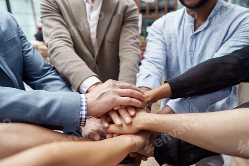 Preview: Top view of group multi ethnic coworkers stacked hands together as concept of corporate unity