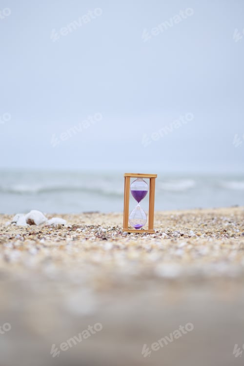 Preview: Vertical photo of hourglass at the beach