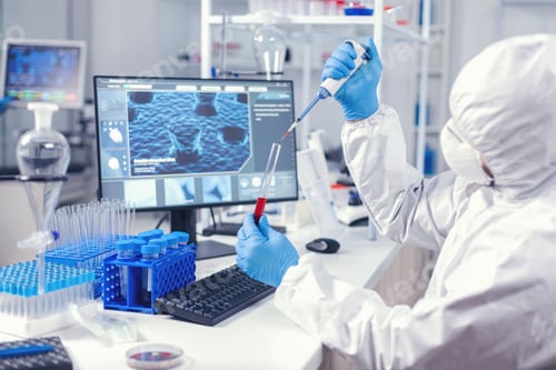 Preview: Medical engineer using dispenser to take sample of blood