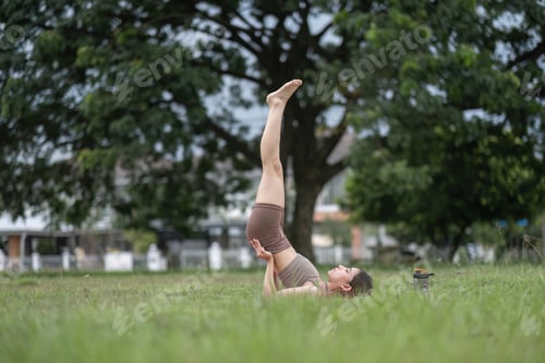 Preview: Young Asian woman exercise Do yoga in the park to improve your health.