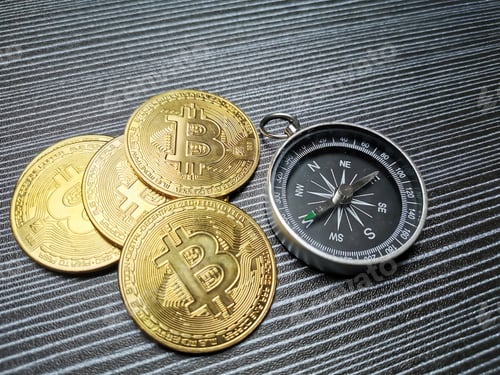 Preview: Photo of bitcoins with magnetic compass on the table.