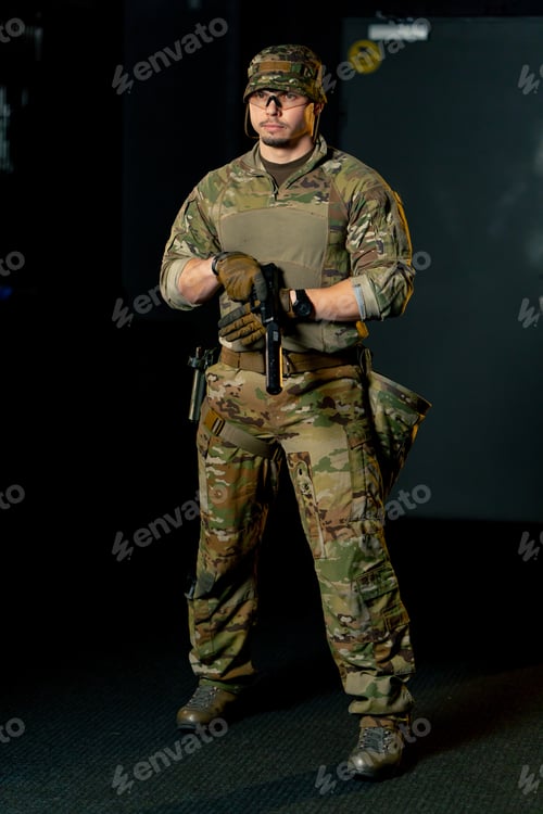 Preview: In a professional shooting range professional fighter stands fully armed during a military exercise