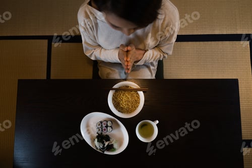 Preview: Woman Preparing to Eat Japanese Meal