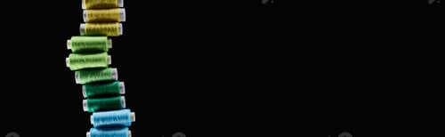 Preview: panoramic shot of bright and colorful threads isolated on black