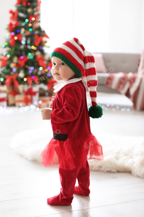 Preview: Cute baby in Christmas costume at home