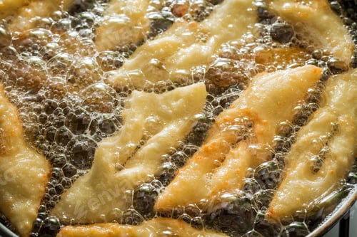 Preview: Closeup of frying delicious and homemade donuts on oil
