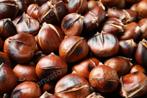 Preview: Pile of delicious edible roasted chestnuts as background, closeup