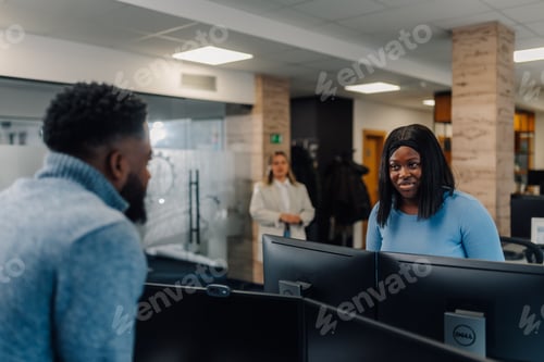 Preview: Programmers collaborating on software development project in modern office