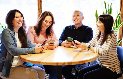 Preview: Four Friends Enjoying Time Together Using Smartphones