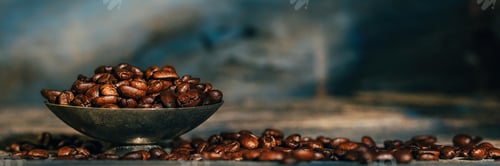 Preview: Coffee beans in old small silver and an the rustic blue wooden table.