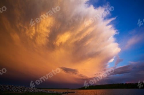 Preview: A cloud formation, a storm cloud reflecting sunlight.