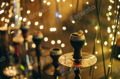 Preview: Single Hookah With Glowing Charcoal Against Fairy Light Bokeh