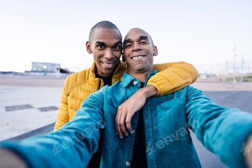 Preview: Funny African American twin brothers taking selfie photo to share with their family