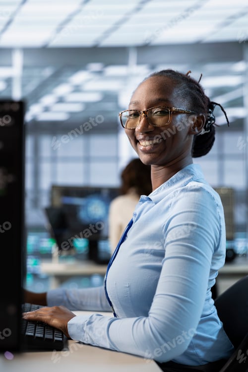 Preview: Portrait of smiling technician in data center testing equipment