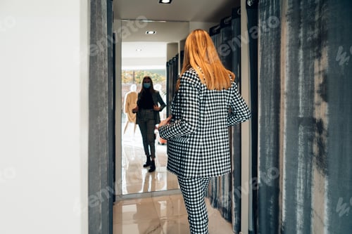 Preview: elegant young caucasian blond woman in a fashion retail shop