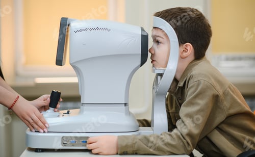 Preview: Ophthalmologist examining eyesight of child with autorefractor in clinic
