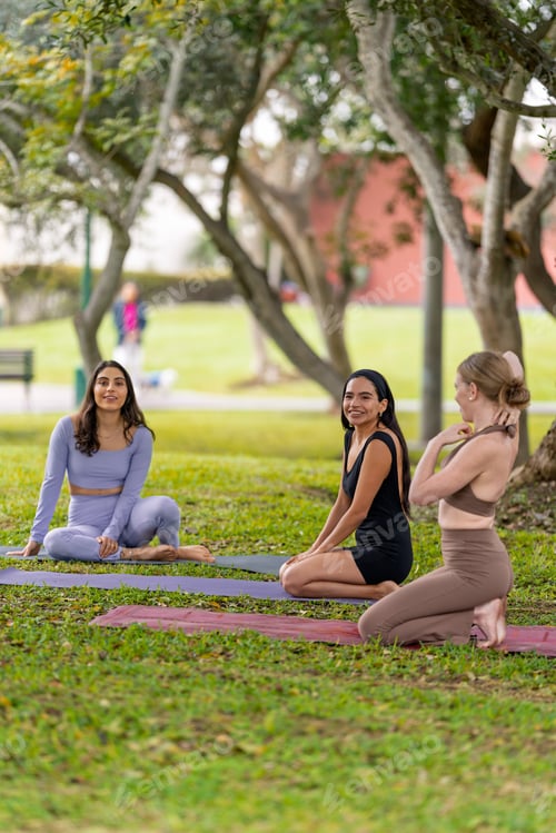 Preview: Women practicing yoga and meditation together in urban park