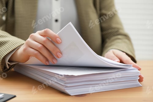 Preview: Woman working with documents at table in office, closeup