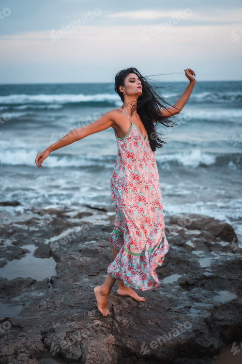 Preview: Posing of a brunette Caucasian in a white fabric dress with flowers