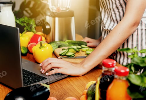Preview: Kitchen. Young woman using laptop for recipe, girl hand click, touch computer