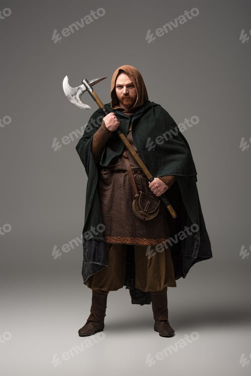 Preview: medieval Scottish redhead man in mantel with battle axe on grey background
