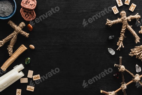 Preview: Top View of Voodoo Dolls Near Bowl With Ashes, Candles, Stones And Old Runes on Black