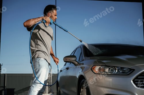 Preview: High pressure, washing the automobile. Man is with his car outdoors