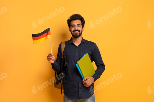 Preview: Education Abroad. Portrait Of Happy Young Indian Student Guy Holding German Flag