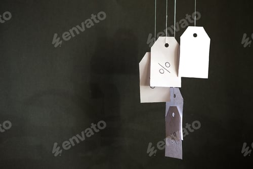 Preview: Hanging Percentage Tags Against Dark Background