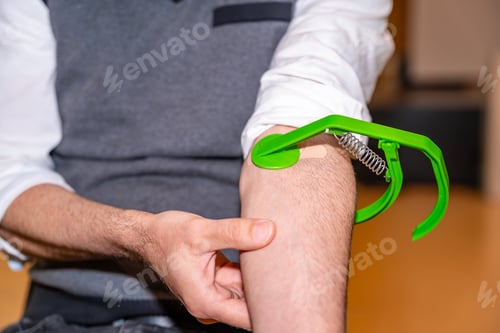 Preview: Man pressing arm to prevent a leak after donating blood
