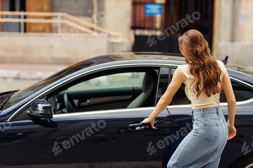 Preview: Happy woman driver at car smiling. Cute young happy brunette female driving car.