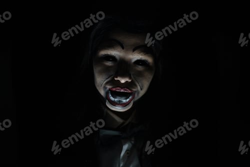 Preview: Scary possessed girl with a creepy doll makeup in a dark room - horror concept