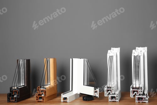 Preview: Samples of modern window profiles on table against gray wall. Installation service