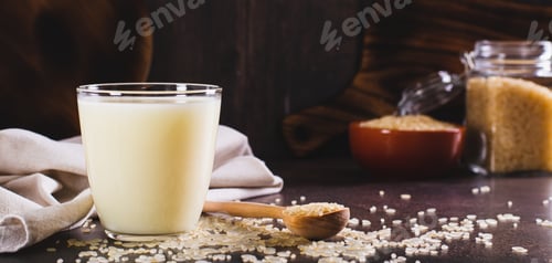 Preview: Lactose-free rice milk in a glass and rice cereal on the table web banner