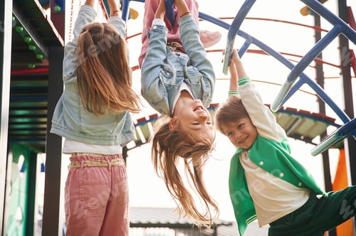 Preview: Hanging upside down. Kids are having fun on the playground