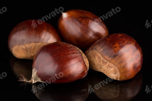Preview: Chestnuts on a black reflective background