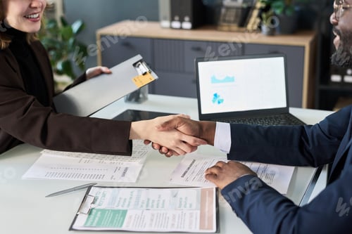 Preview: Business Colleagues Shaking Hands At Meeting