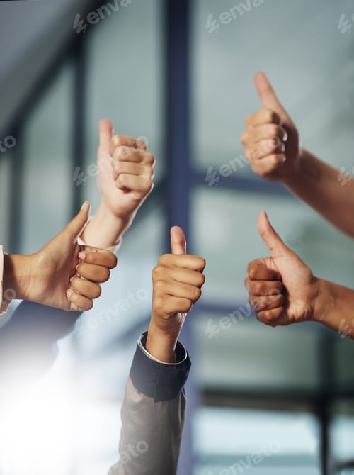 Preview: Great effort. Cropped shot of a group of unrecognisable businesspeople showing thumbs up.