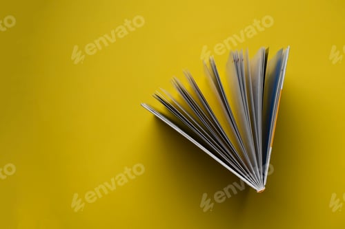 Preview: a directly above view of the opened book on pastel background, spreaded pages