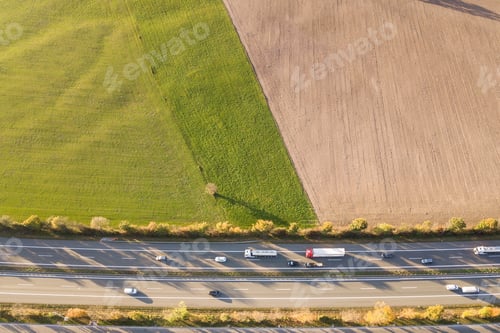 Preview: Top down aerial view of highway interstate road with fast moving traffic and parking lot