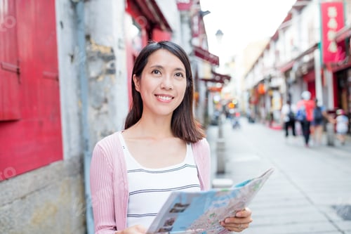 Preview: Woman looking at city map in Macao city