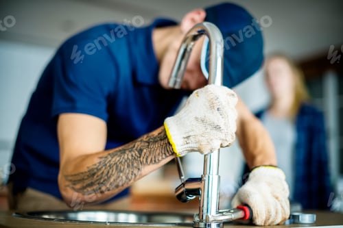 Preview: Plumber fixing kitchen sink