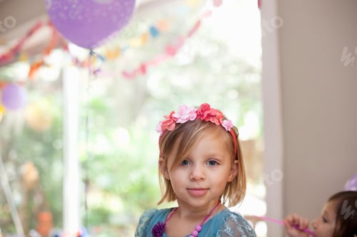 Preview: Portrait of blonde girl with flower headband smiling at camera