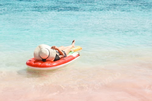 Preview: Woman sunbathing on inflatable