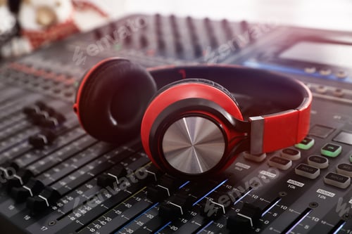 Preview: Headphones on professional mixing console in modern radio studio, closeup